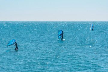 Windsurfers on the sea surface at morning.