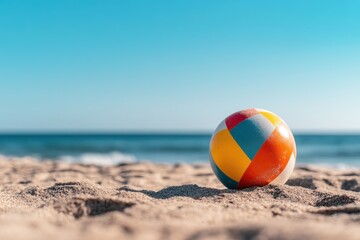 Beach ball on the sand by the sea