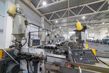 Extrusion machines processing plastic granules in factory