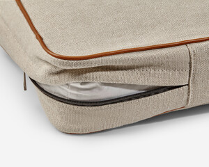Close-up of removable cushion cover showing zipper and interior filling