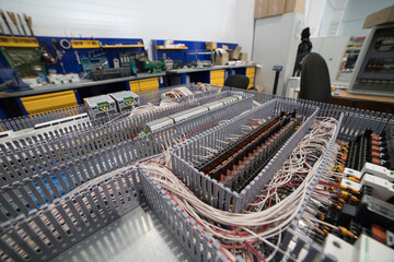 Electrical cabinet under assembly showing relays, wires and terminals in workshop