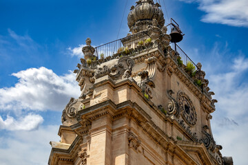 Detail of the baroque bell tower of the Cathedral of St. George in Modica, Sicily, Italy, with blue...