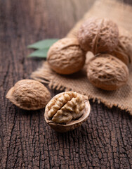 Cracked walnut on rustic old wooden table.