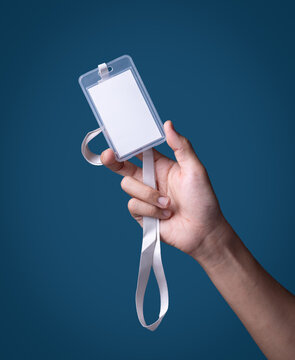 Man's hand holding id badge on blue background