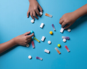 Sugar feast concept, top view image of sugar feast concept,Child's hands picking colorful fruit jelly candies.