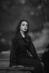 Naklejka premium beautiful brunette european girl in blue trench coat at nature. Young lady with beautiful face and lips.
