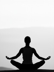 black and white photo of a human silhouette meditating