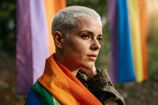 Portrait of a Young Person from the LGBTQIA+ Community Wrapped in Rainbow Pride Flag