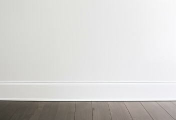 A white wall and wooden floor in an empty room.