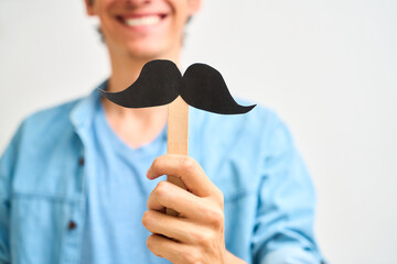 Cheerful Latin man showing a black mustache. Prostate cancer, awareness concept, men Health