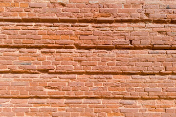 Textured Red Brick Wall with Horizontal Indentations