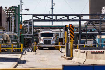 Industrial Freight Truck at Factory Entrance with Complex Piping System