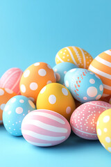 Fototapeta premium Colorful decorated Easter eggs arranged on a blue background, creating a festive atmosphere