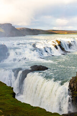 Majestic Multitiered Waterfalls with Expansive Mist in Scenic Landscape