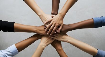 Diverse hands together forming a star shape representing unity and collaboration.