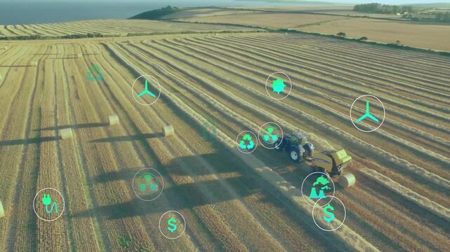 Displaying aerial farmland with blue tractor towing yellow baler moving through rows with eco icons