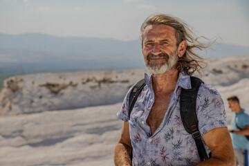 Joyful traveler enjoying the breathtaking landscapes of Pamukkale in Turkey on a sunny summer day