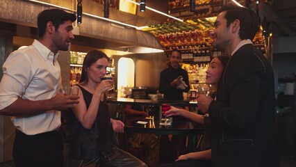Man with couple standing fronted bar while friend walking to cheers cocktail in Paloma, Margarita, Old fashioned and Martini while bartender making special party beverage vibrant nightclub. Vinosity.