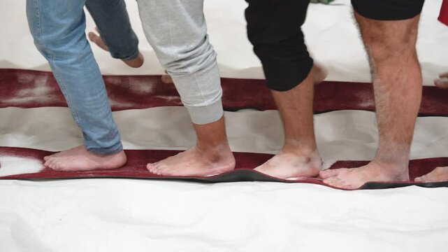 Corporate Team Development Activity With Barefoot Participants Practicing Unified Step Changes Across Textile Pathways