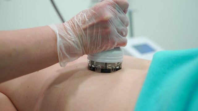 RF massage. Hardware cosmetology. Young woman getting rf lifting procedure in a beauty parlour.