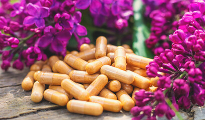 Lilac flowers extract and dietary supplements. Selective focus.