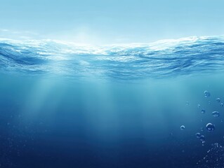 Serene Underwater Scene with Sunlight Filtering Through Clear Blue Water Surface Ripples