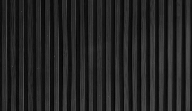 uniformly textured surface composed of numerous parallel, dark black wooden slats arranged vertically, creating a clean and simple pattern with subtle variations in tone and shadow.