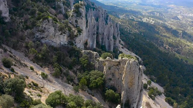 Aerial view of Els Frares. The topography, with its rock formations, casts a striking silhouette. Its striking structures resemble monks turned to stone, in Alicante, Spain.