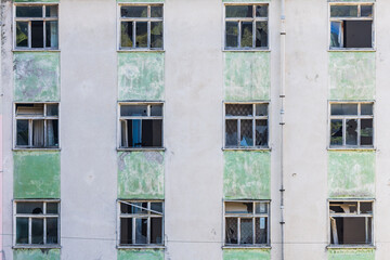Broken windows in an abandoned apartment building.