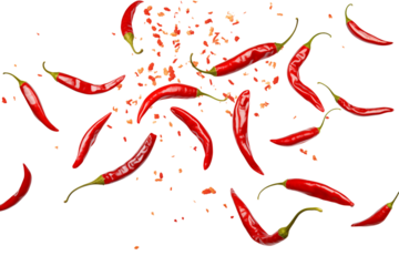Scattered red chili peppers with green stems and flakes against a creating a spicy scene transparent background png