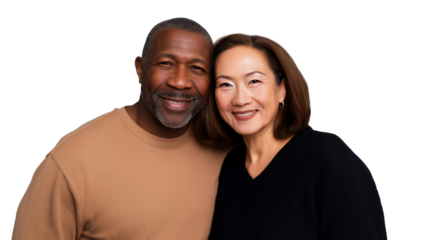 Older Inter-racial couple of African-American man and Asian woman smiling and embracing, isolated on white or transparent background