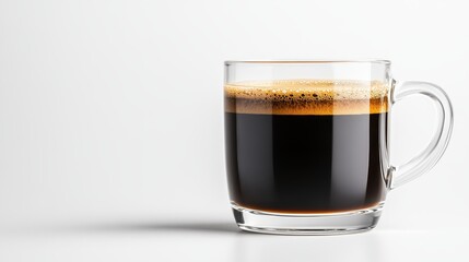 A clear glass mug filled to the brim with strong black coffee displays its rich texture, capturing the essence of a perfect morning drink and an invigorating start to the day.