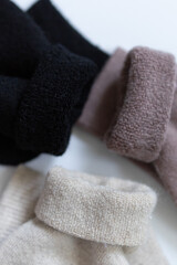 Close-up texture socks three pairs of warm socks on white background white brown black