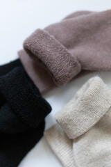 Close-up texture socks three pairs of warm socks on white background white brown black