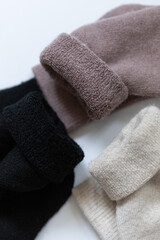 Close-up texture socks three pairs of warm socks on white background white brown black
