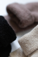 Close-up texture socks three pairs of warm socks on white background white brown black