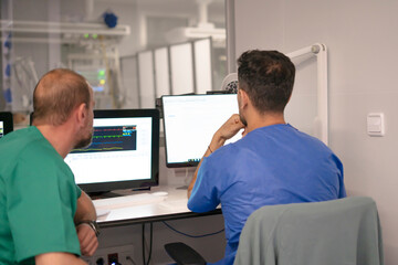 Obraz premium Medical team analyzing data on computer monitors in hospital control room