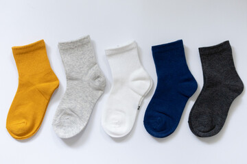 5 Pairs of children's socks in Blue, gray, mustard, yellow, white on a white background