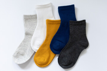 5 Pairs of children's socks in Blue, gray, mustard, yellow, white on a white background