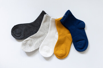 5 Pairs of children's socks in Blue, gray, mustard, yellow, white on a white background