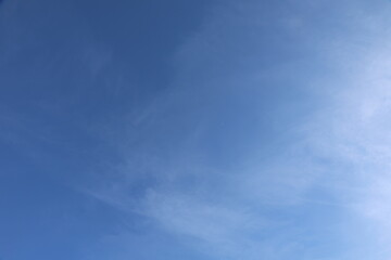 Blue Sky with Wispy Clouds and Crescent Moon
