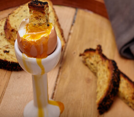 organic
Part boiled egg with toasted soldiers,with yoke running down the egg.

