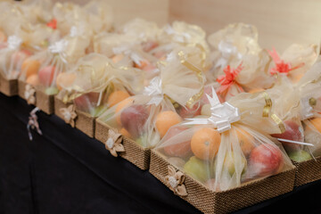 Elegant fruit baskets filled with fresh produce, wrapped in decorative fabric and ribbon, perfect for gifting or special occasions. Healthy and delightful!