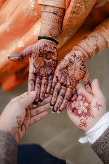 Bridal Mehndi: A couple showcases intricate henna designs on their hands, symbolizing love, commitment, and cultural celebration.
