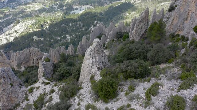 Aerial view of Els Frares. The topography, with its rock formations, casts a striking silhouette. Its striking structures resemble monks turned to stone, in Alicante, Spain.