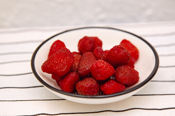 Chips from dried strawberries, sliced into thin slices. Background for healthy eating and vegetarianism. Snacks