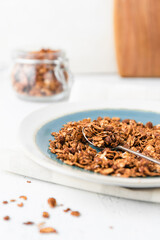 Granola or baked oat flakes with chocolate and nuts. Healthy and simple breakfast.