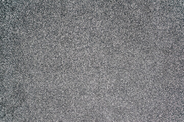Close-up texture of a wall made of fine granite chips in black and white. House facade decor...