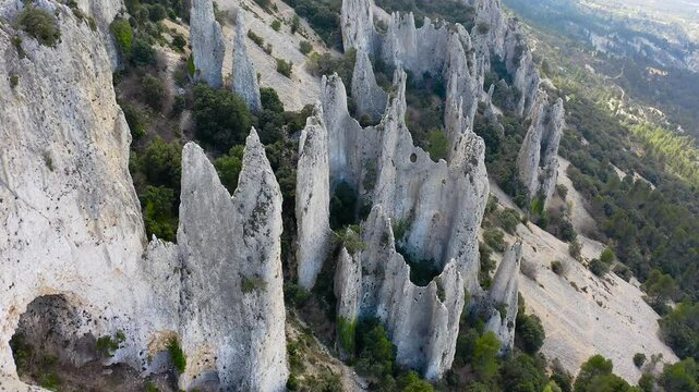Aerial view of Els Frares. The topography, with its rock formations, casts a striking silhouette. Its striking structures resemble monks turned to stone, in Alicante, Spain.