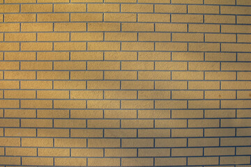 Fototapeta premium Uniform Yellow Brick Wall Texture With Horizontal Pattern Creating Minimalist Background Design